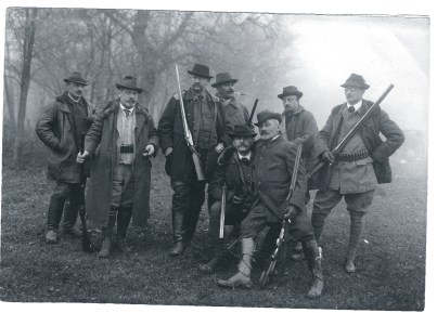 Nobility posing with guns during a hunt around 1910