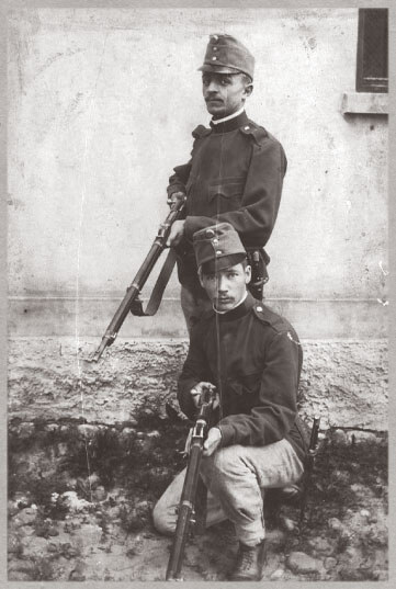 Two Hungarian soldiers in uniform posing with their guns