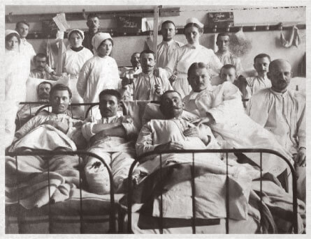 Wounded Austro-Hungarian soldiers recovering in a war hospital with nurses in the background