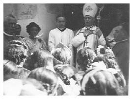 Bishop visiting Marcali Hungary and addressing small crowd in 1940