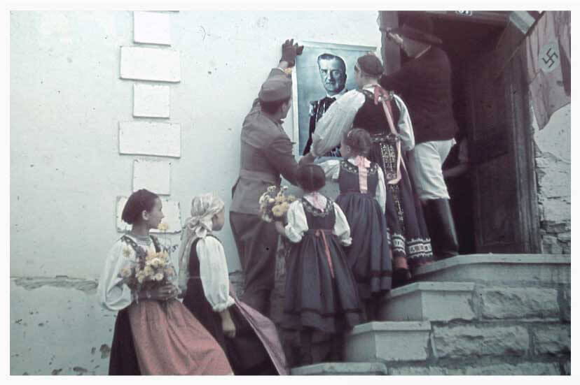 Hungarian troops hanging a large poster of Miklós Horthy in Nagydemeter Romania in 1940
