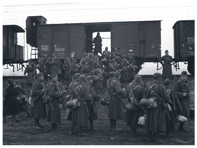 Groups of Hungarian soldiers in front of empty railway cars in 1941