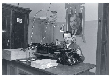 Communist Party member fixing a typewriter