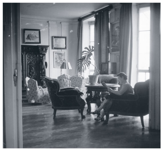 Woman reading a magazine in an elegant living room