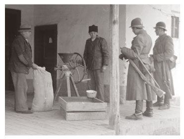 Police inspectors checking bags of grain during the Rákosi era