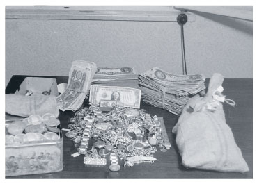 Confiscated dollars, marks, and jewelry resulting from a police search during the Rákosi era
