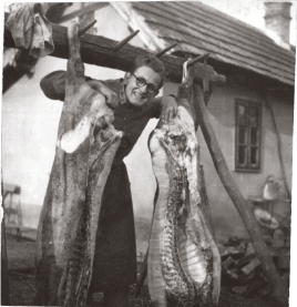 Gyula on the family farm with meat carcasses in 1950
