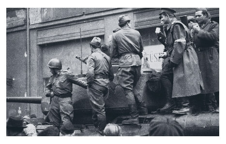 Freedom fighters standing on tanks during the 1956 Hungarian Revolution