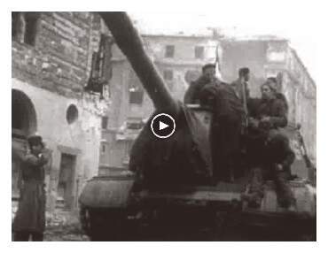 Looped video footage showing Hungarian freedom fighters atop a Soviet tank and advancing towards the viewer