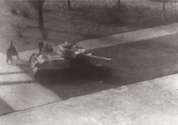 Looped video footage on the left side of the screen showing menacing Soviet tanks advancing from left to right