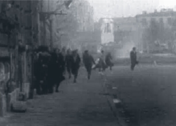 Looped video footage on the right side of the screen showing Hungarians running to escape gunfire