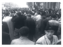 Looped video footage showing a Budapest crowd full of energy, anticipation and anxiety during the 1956 Hungarian Revolution