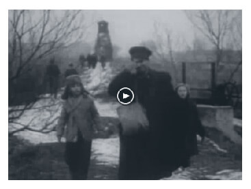 Looped video footage showing weary Hungarian family of four, a father holding the hand of his son followed by a mother holding the hand of their daughter and walking in the snow towards the Austrian border