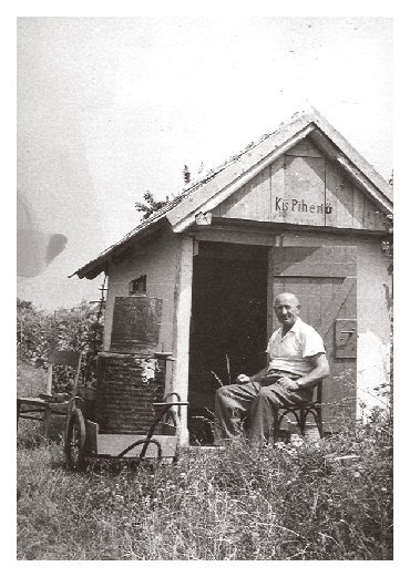 Pista sits by his farming shack around 1970