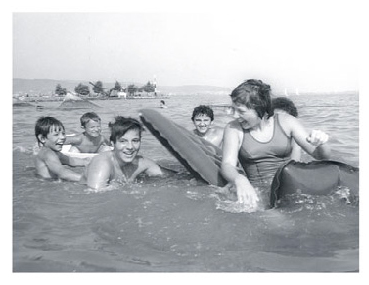 Laci splashes in Lake Balaton with Adrian and Anita and other friends in 1976.