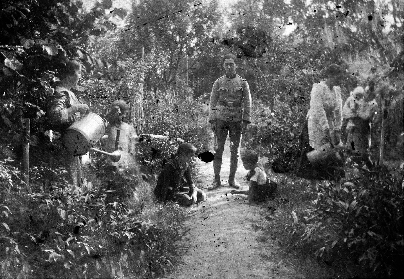 A Hungarian soldier returning home to family in garden in 1918