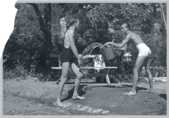 Men in bathing suits throwing water