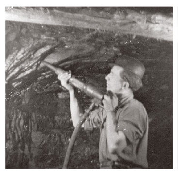 A miner drilling underground