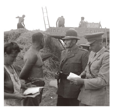 Policemen monitoring kulaks on a farm in Hungary in 1950