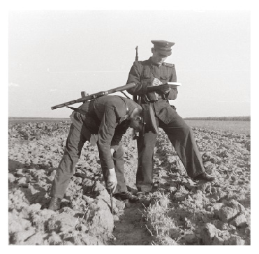 Policemen monitoring collective farm workers in Hungary in 1950