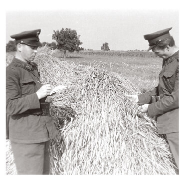 Policemen monitoring collective farm workers in Hungary in 1950