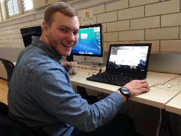 Collin sitting at his computer.