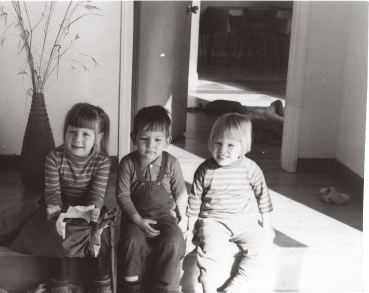 Anita and Adrian and Bettina Fabos as children sit on the steps of their home in Amherst Massachusetts